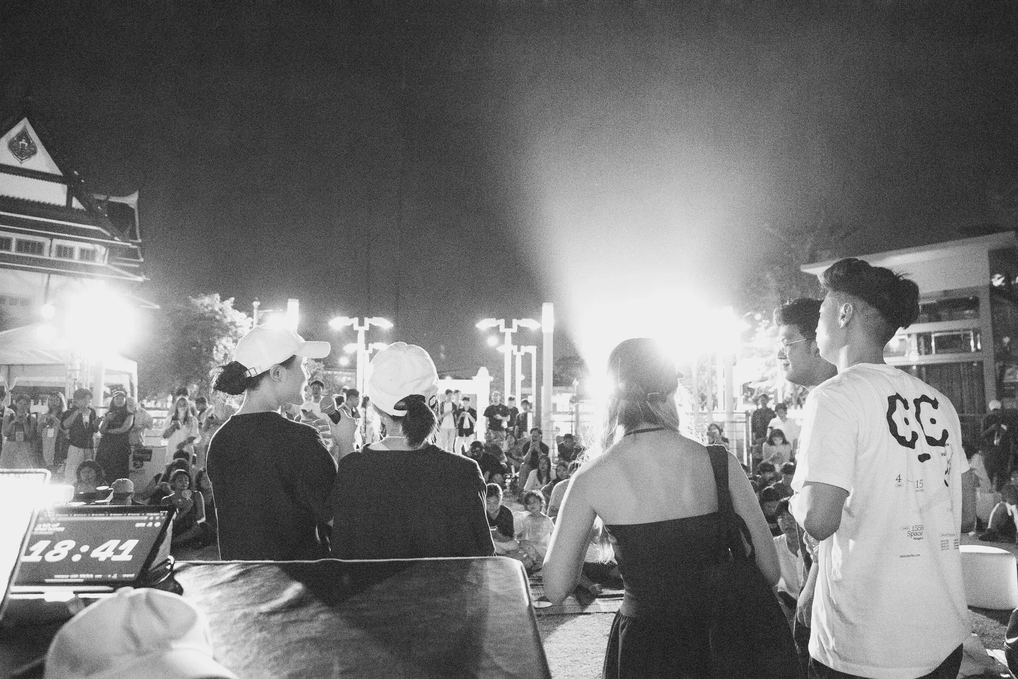 Performers and crew watching the projection from behind the stage