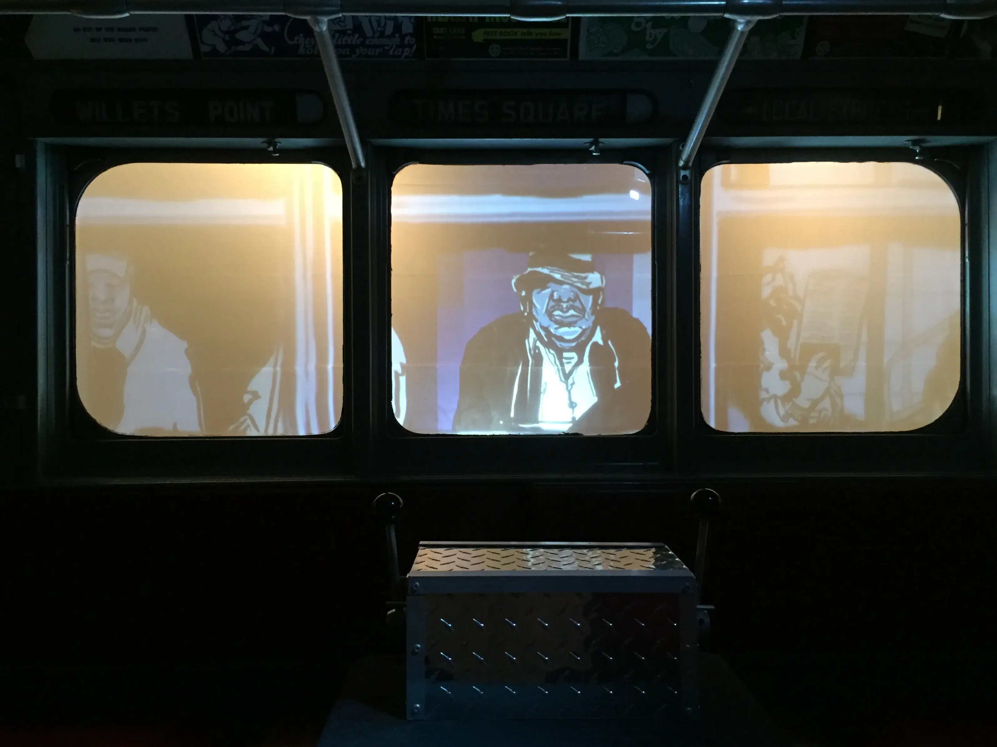 Subway Stories projected onto the windows of a decommissioned subway car, with characters visible through the glass and a metal crate interface in the foreground