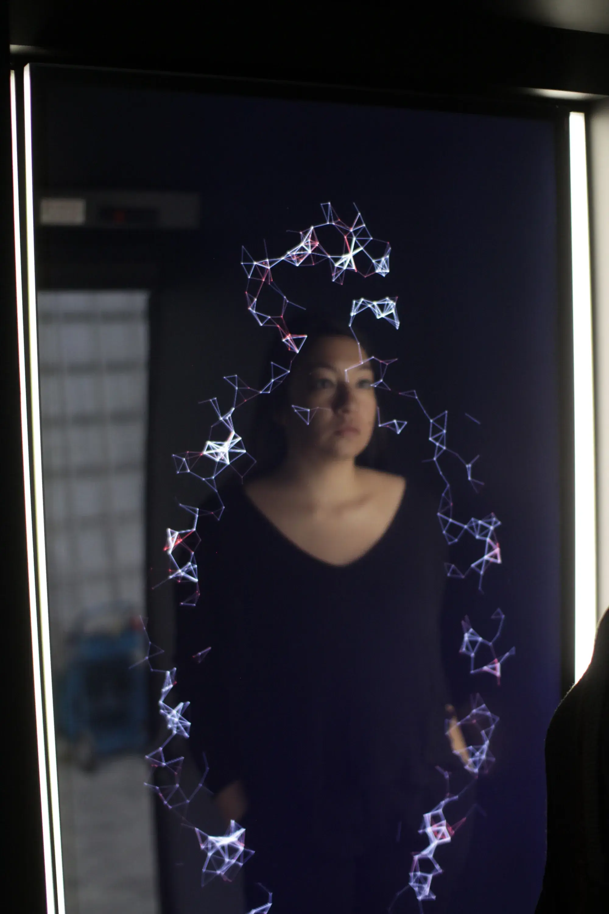 Biometric mirror display inside the bus reflecting a visitor's face with data overlay