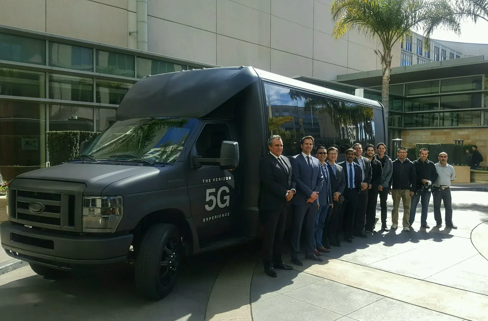 Verizon executives and press viewing the 5G bus demonstration